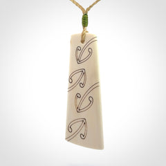 Hand carved bone toki pendant