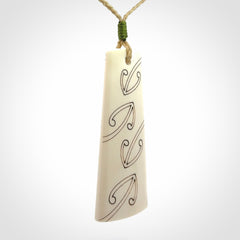 Hand carved bone toki pendant