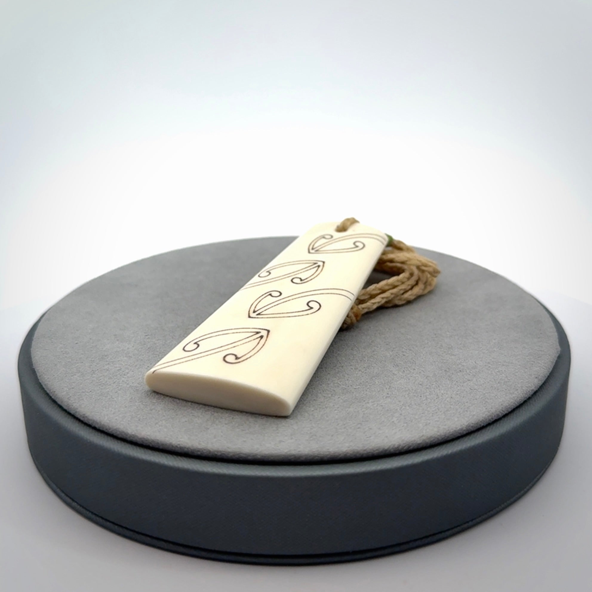 Hand carved bone toki pendant