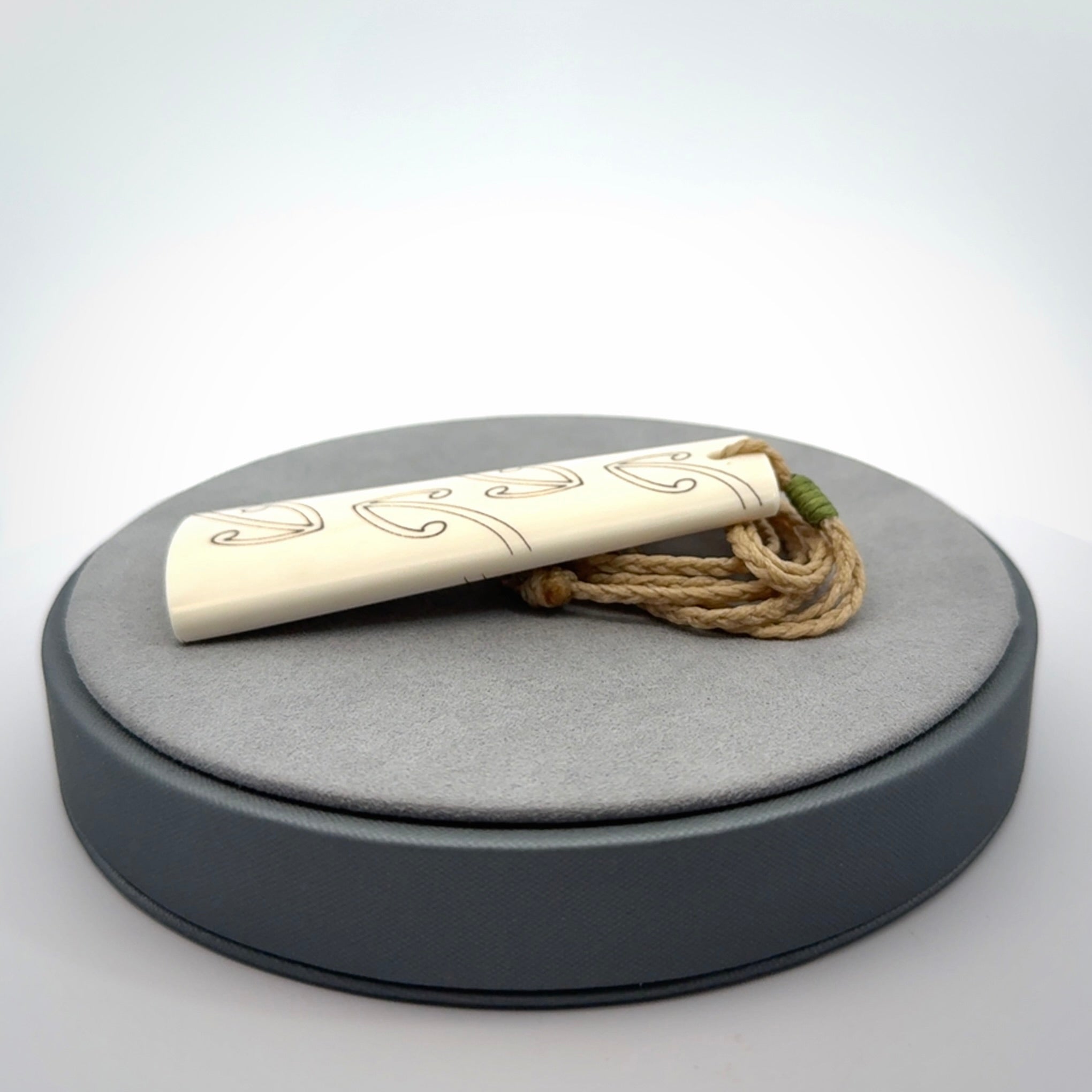 Hand carved bone toki pendant
