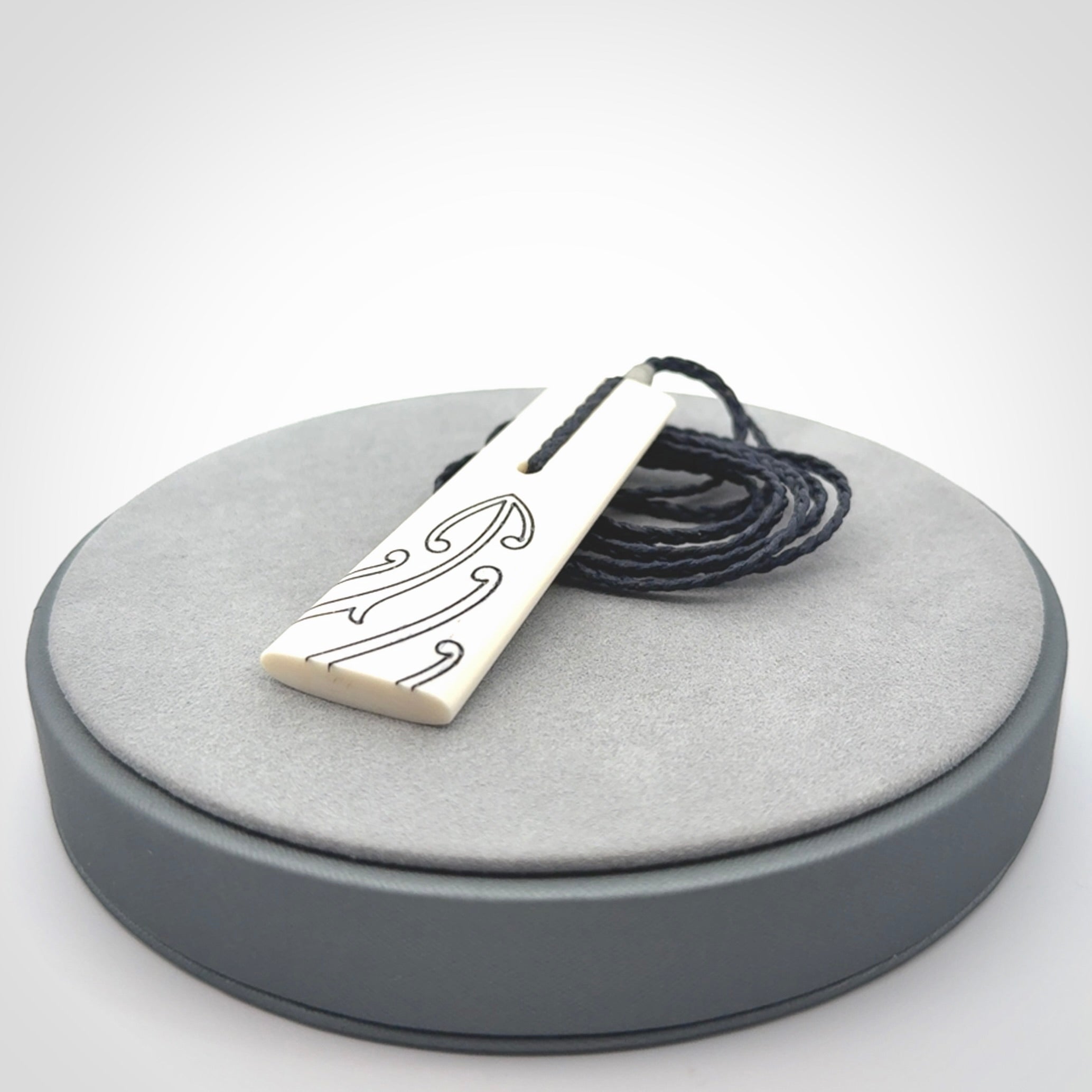 Hand carved bone toki pendant