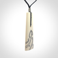 Hand carved bone toki pendant