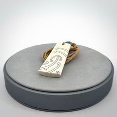 Hand carved bone toki pendant