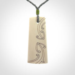 Hand carved bone toki pendant