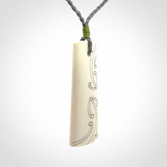 Hand carved bone toki pendant
