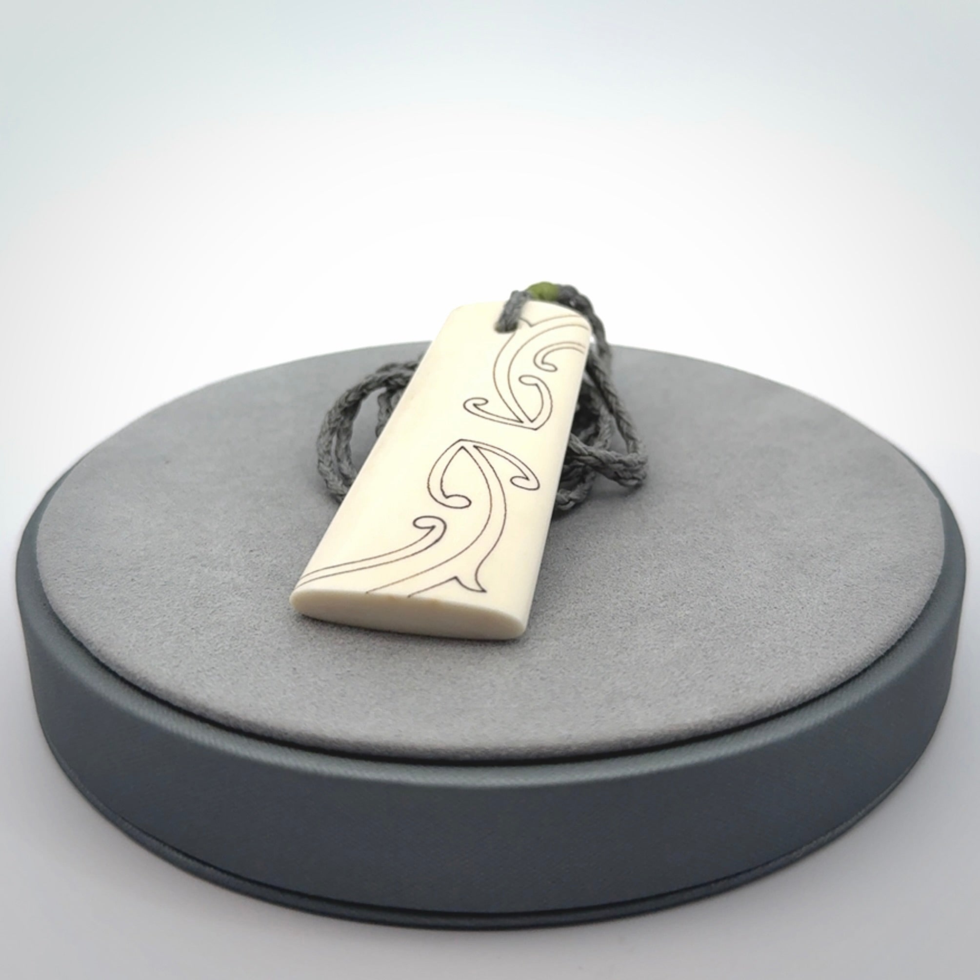 Hand carved bone toki pendant