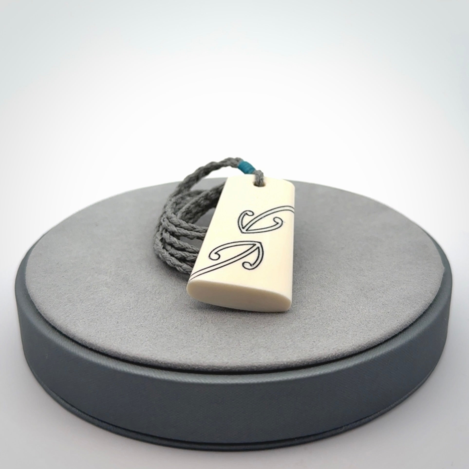 Hand carved bone toki pendant