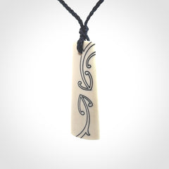 Hand carved bone toki pendant