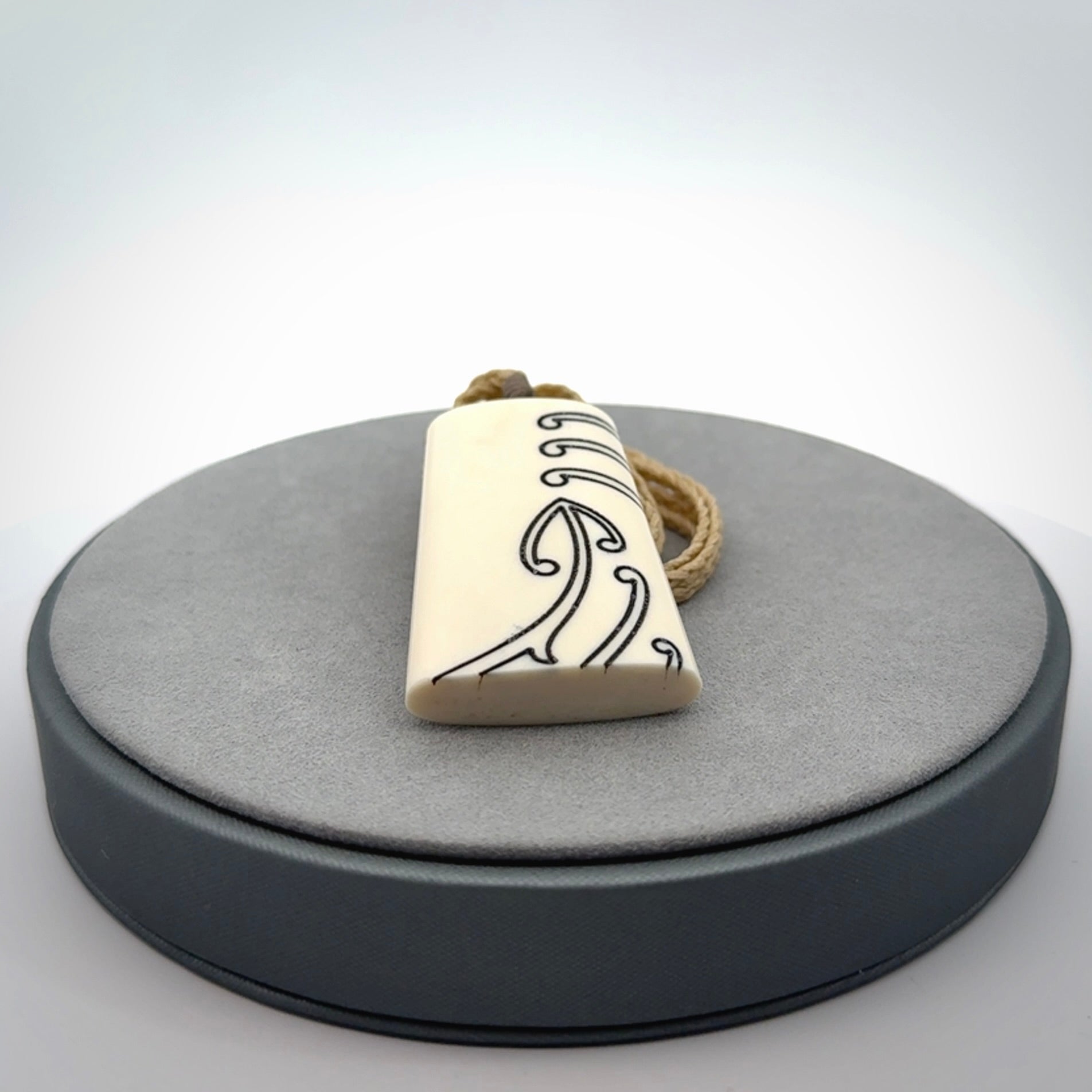 Hand carved bone toki pendant