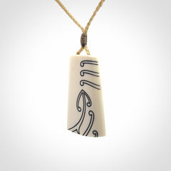 Hand carved bone toki pendant
