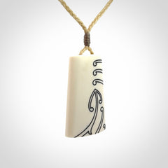Hand carved bone toki pendant