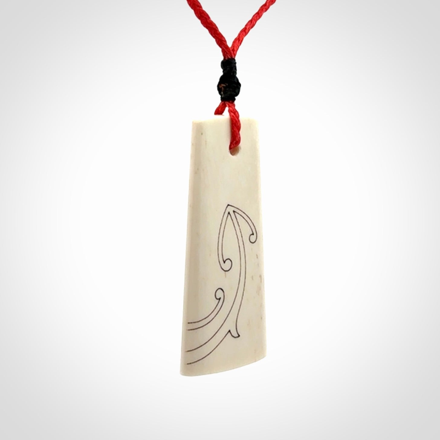 Hand carved bone toki pendant