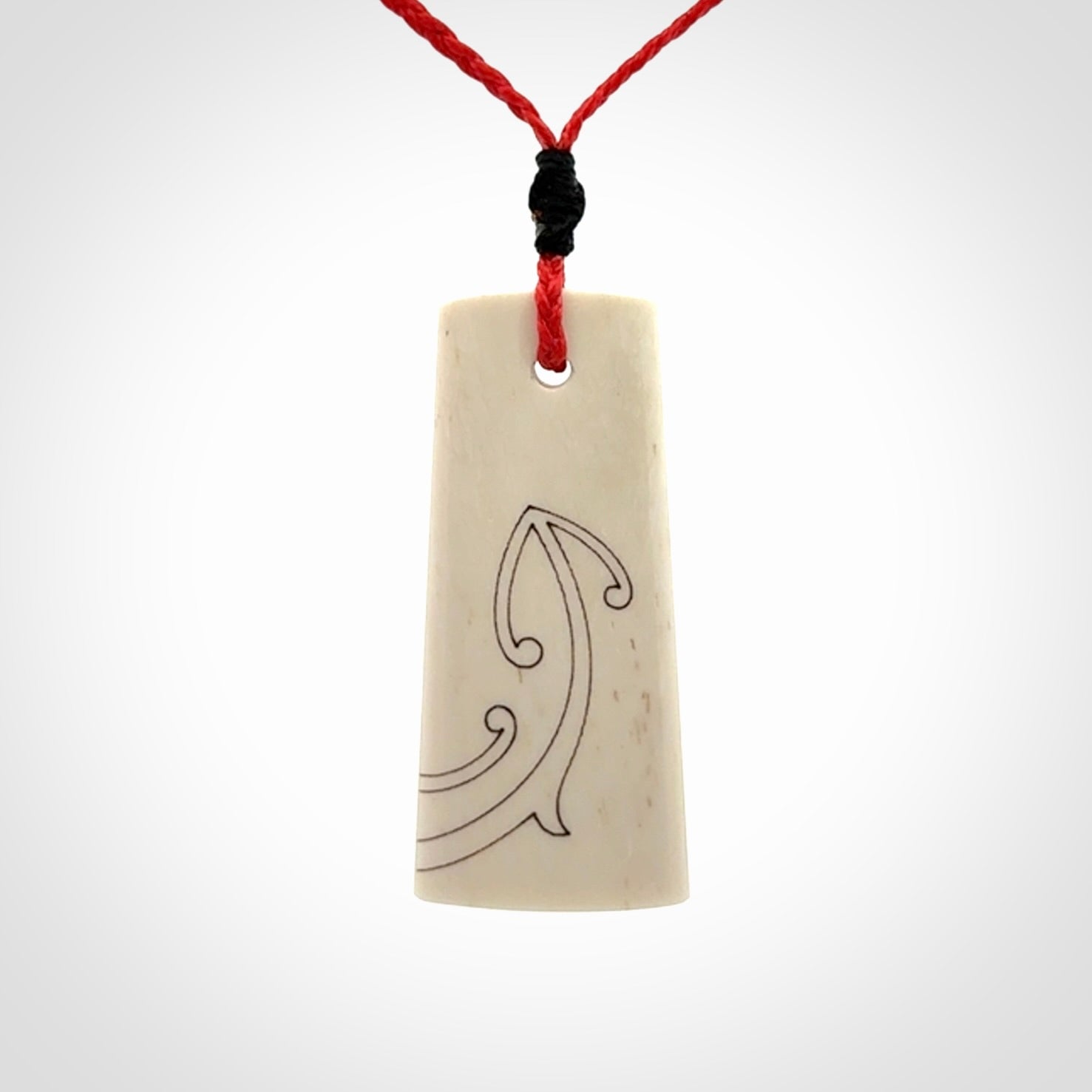 Hand carved bone toki pendant