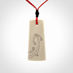Hand carved bone toki pendant