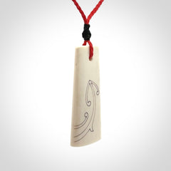 Hand carved bone toki pendant