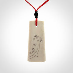 Hand carved bone toki pendant
