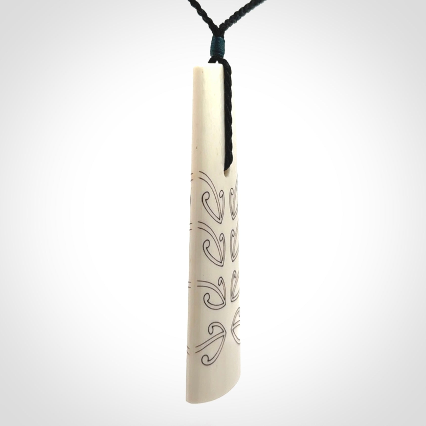 Hand carved bone toki pendant