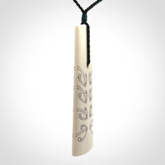 Hand carved bone toki pendant