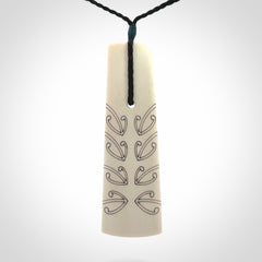 Hand carved bone toki pendant