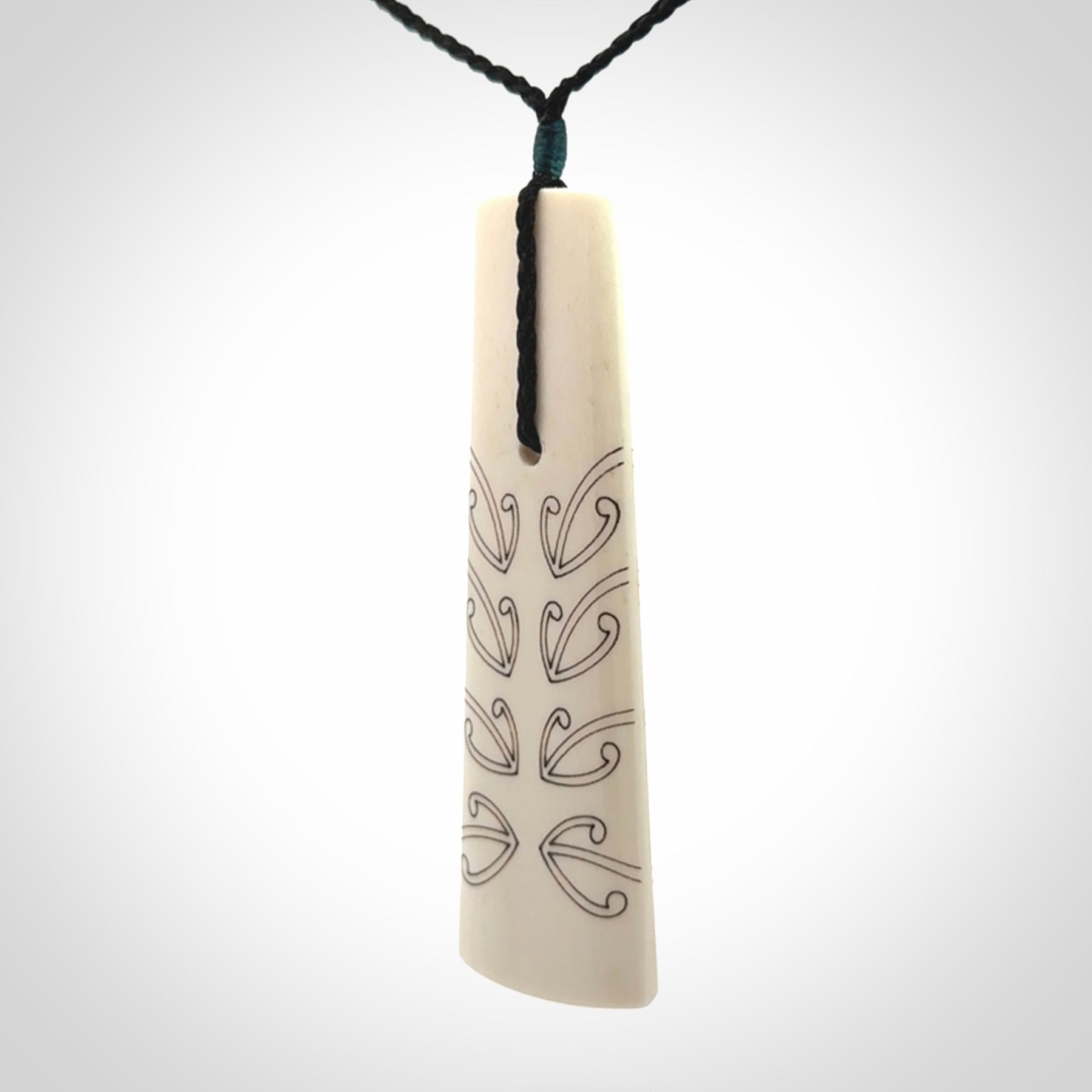 Hand carved bone toki pendant