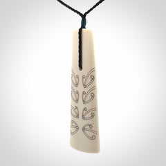 Hand carved bone toki pendant