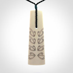 Hand carved bone toki pendant