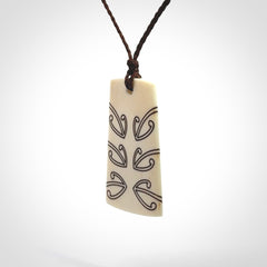 Hand carved bone toki pendant