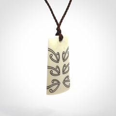 Hand carved bone toki pendant