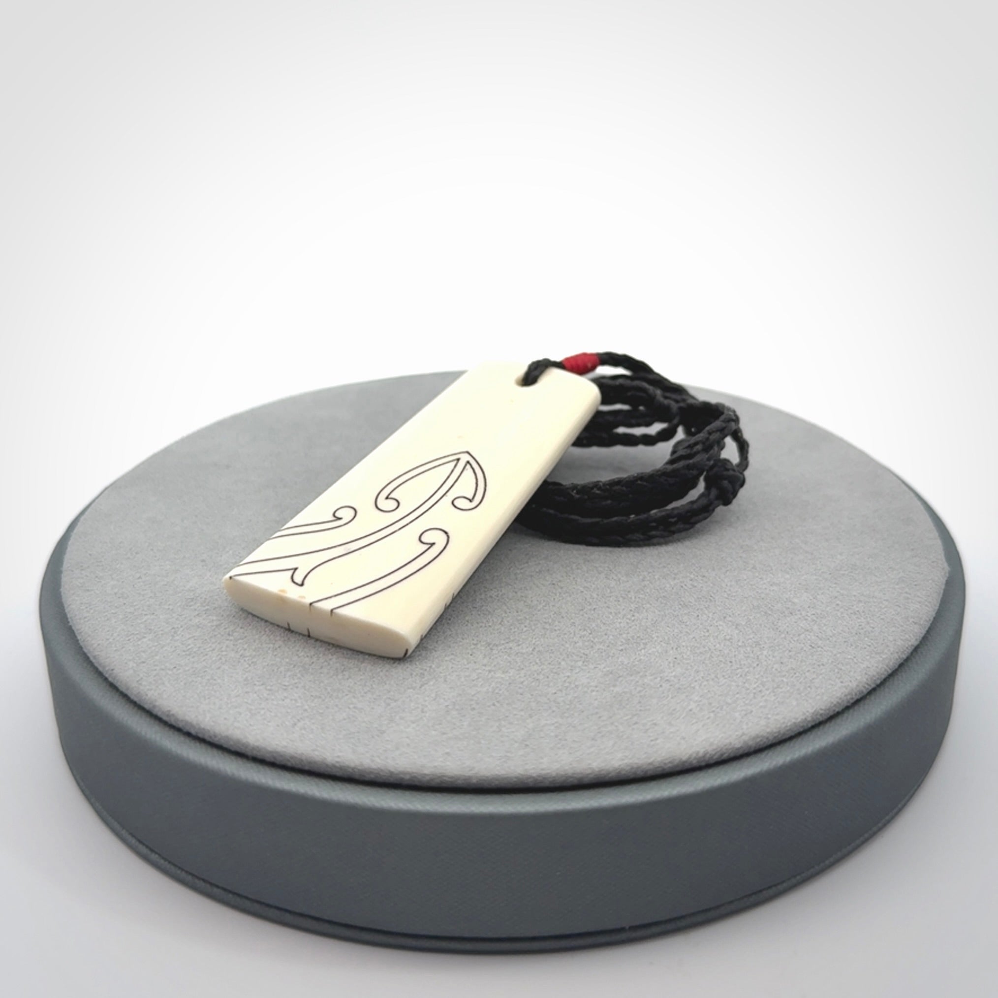 Hand carved bone toki pendant