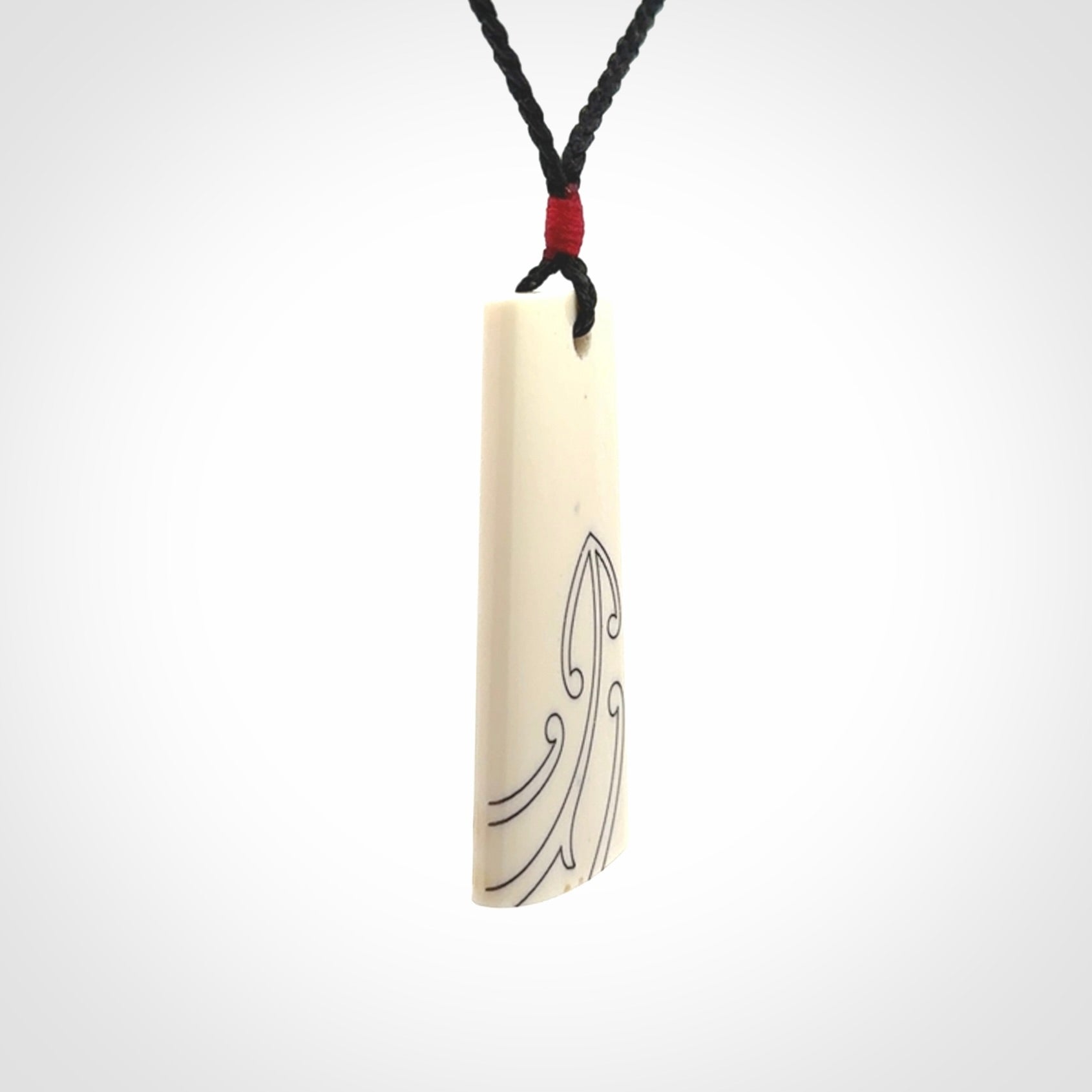 Hand carved bone toki pendant