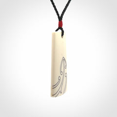 Hand carved bone toki pendant