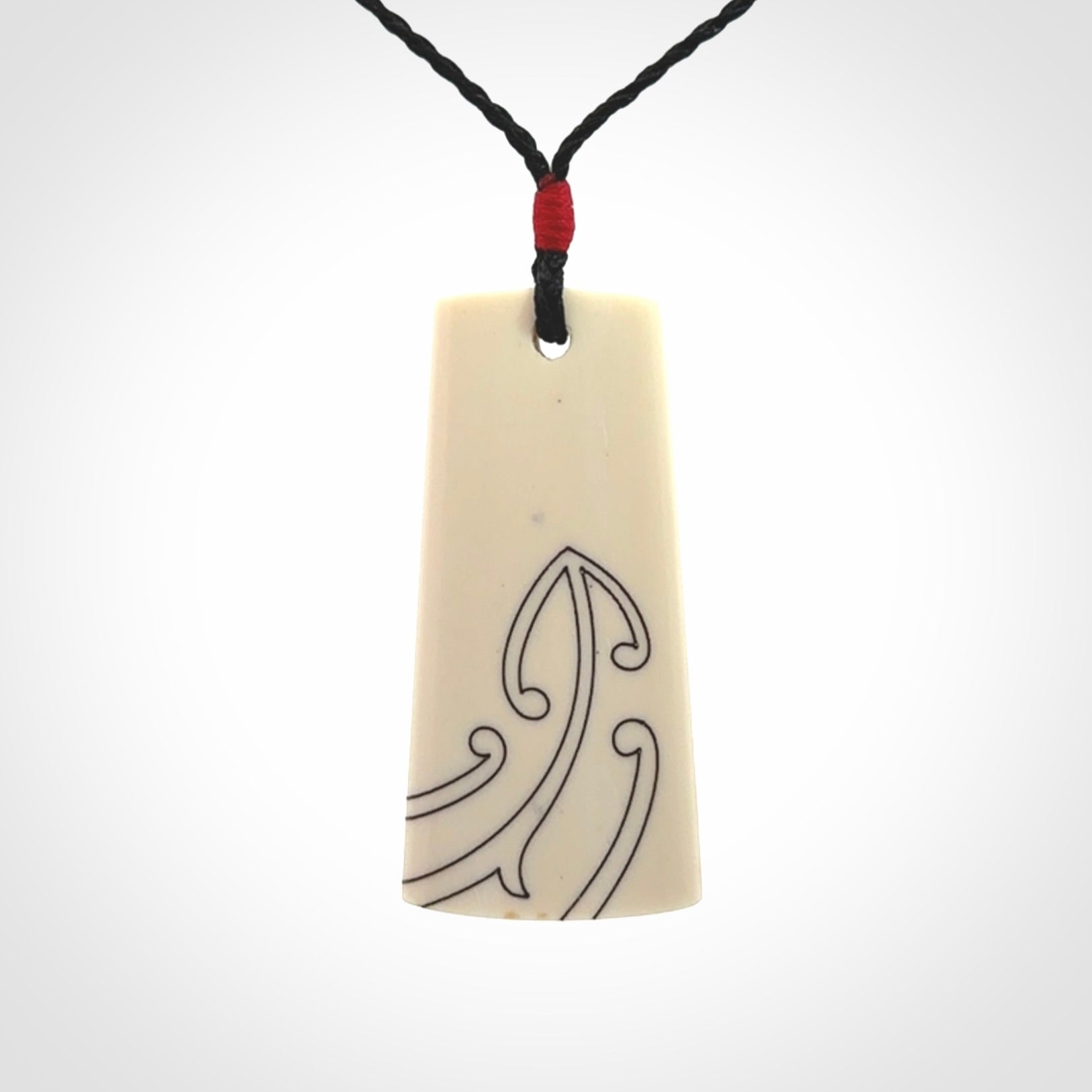 Hand carved bone toki pendant