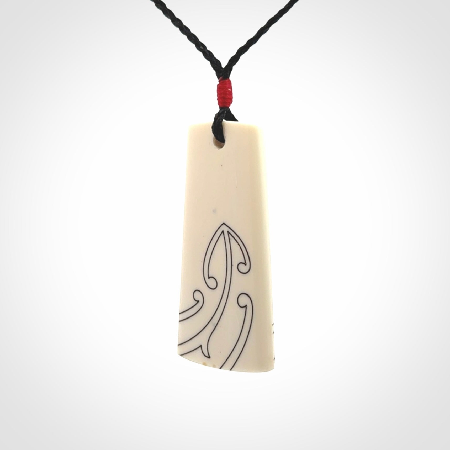Hand carved bone toki pendant