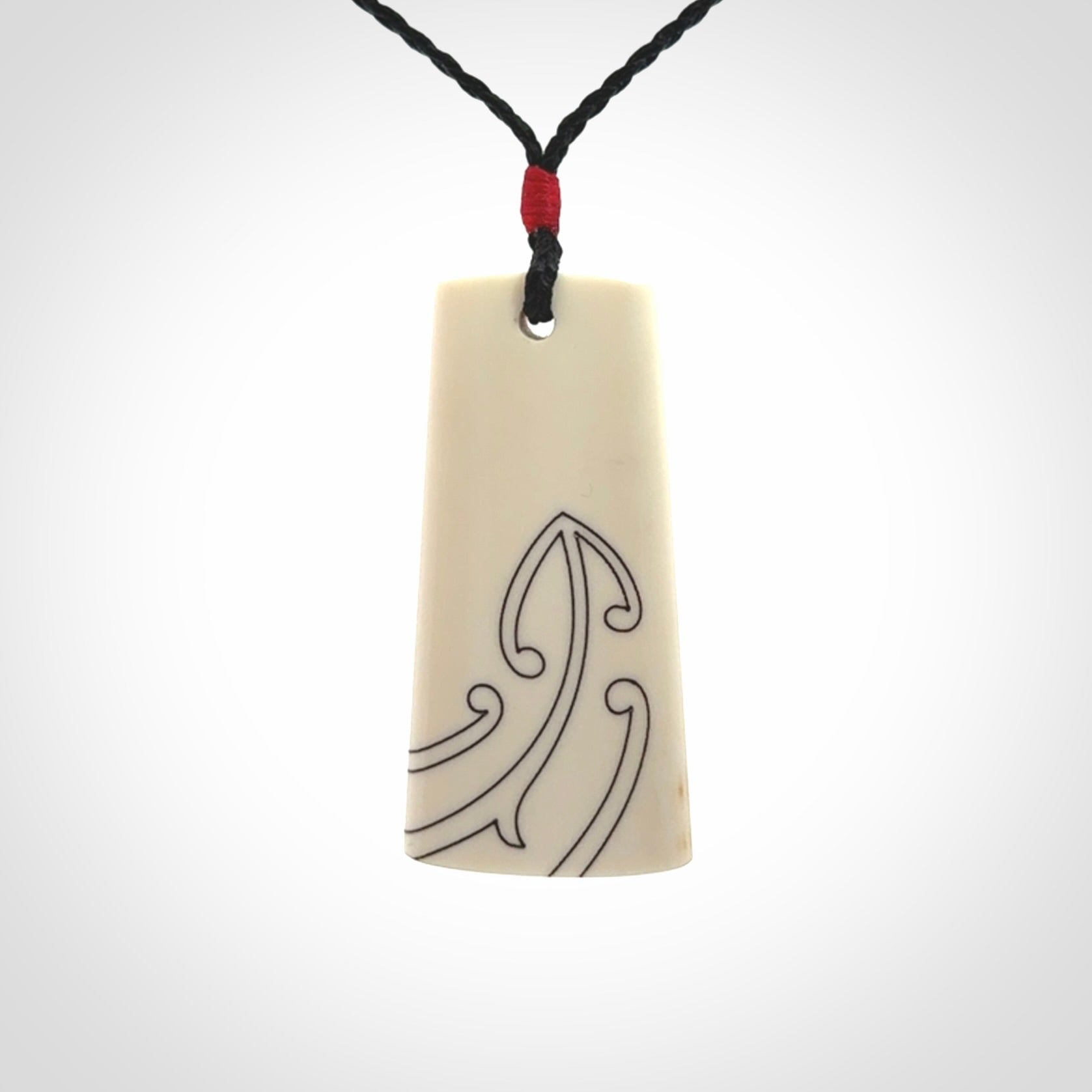 Hand carved bone toki pendant