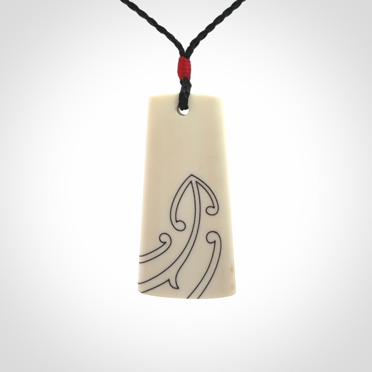 Hand carved bone toki pendant