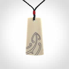 Hand carved bone toki pendant