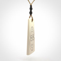 Hand carved bone toki pendant