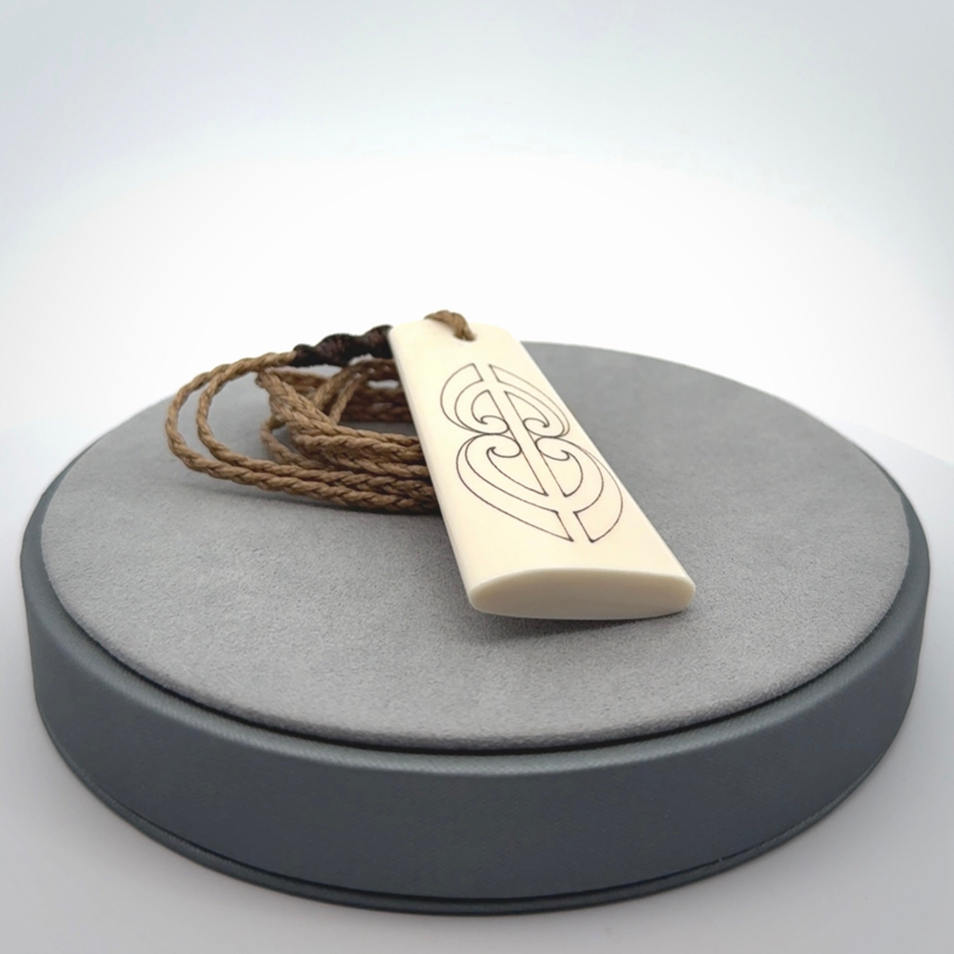 Hand carved bone toki pendant
