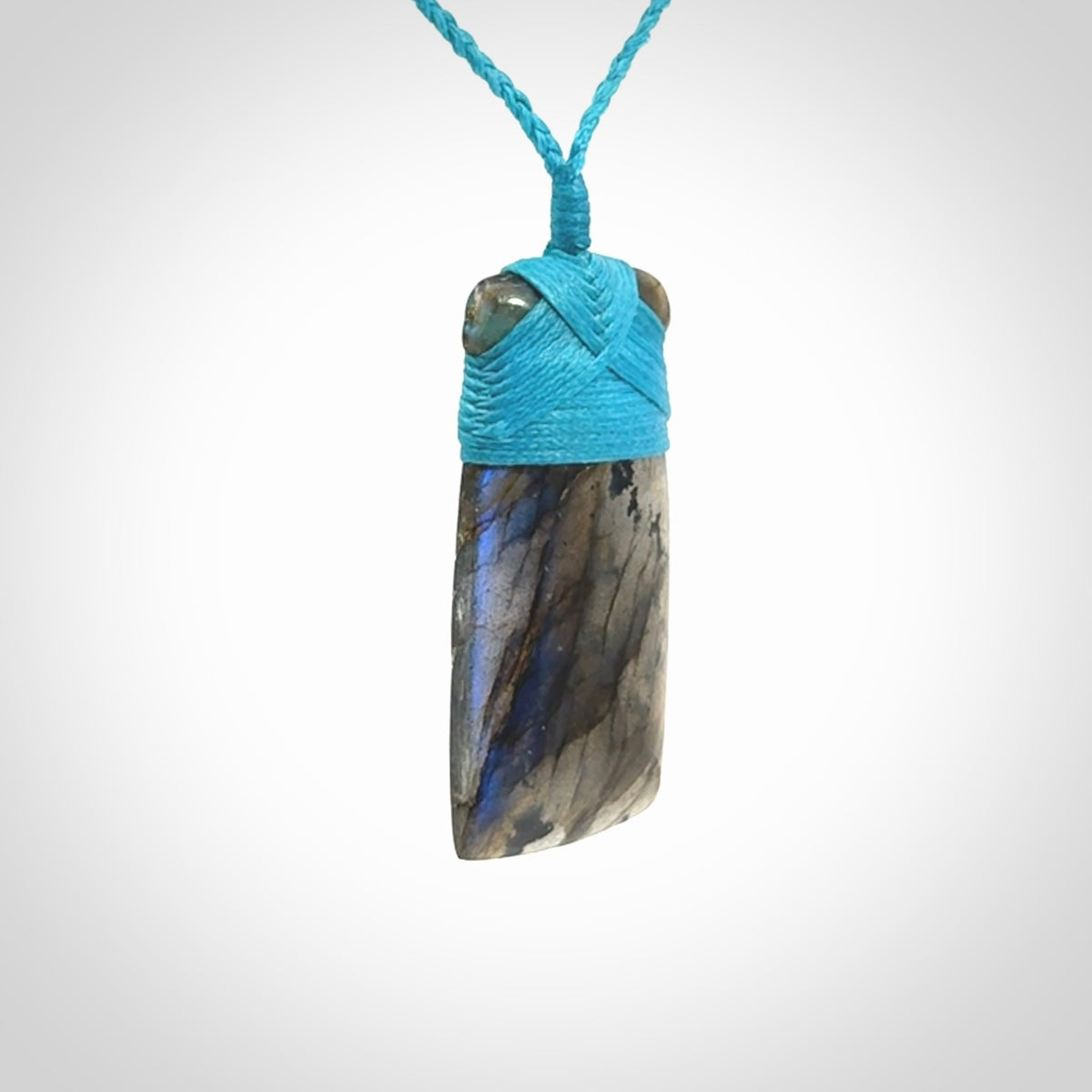 This picture shows a Labradorite stone toki pendant that we have hand carved.