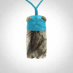 This picture shows a Labradorite stone toki pendant that we have hand carved.