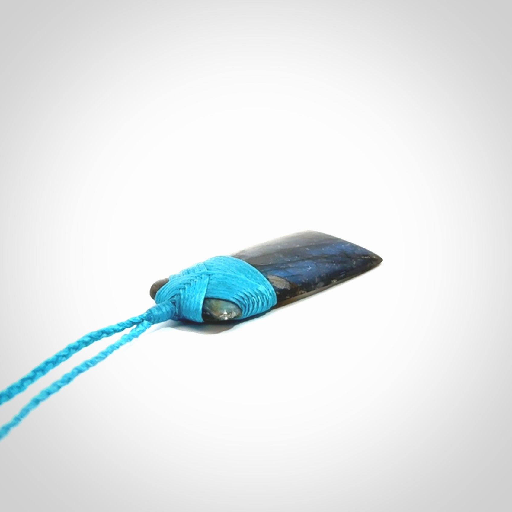 This picture shows a Labradorite stone toki pendant that we have hand carved.