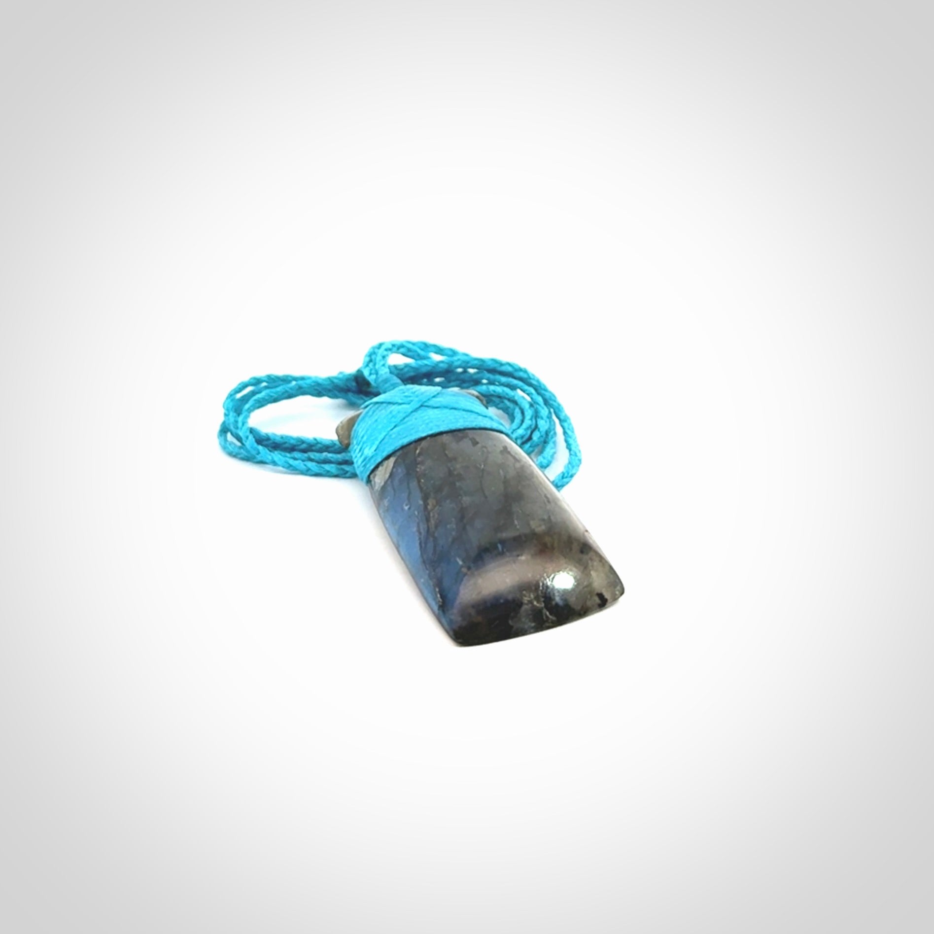 This picture shows a Labradorite stone toki pendant that we have hand carved.