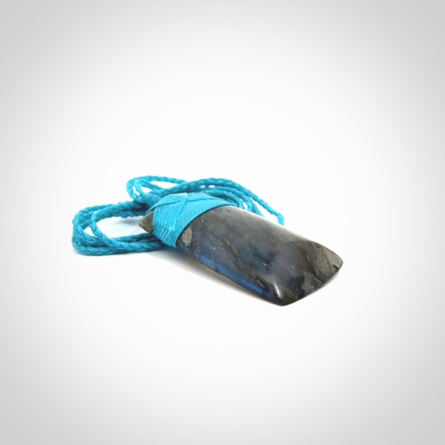 This picture shows a Labradorite stone toki pendant that we have hand carved.