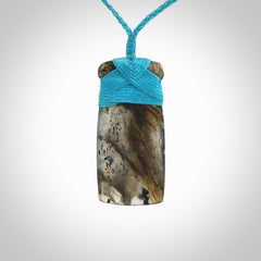 This picture shows a Labradorite stone toki pendant that we have hand carved.