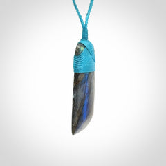 This picture shows a Labradorite stone toki pendant that we have hand carved.