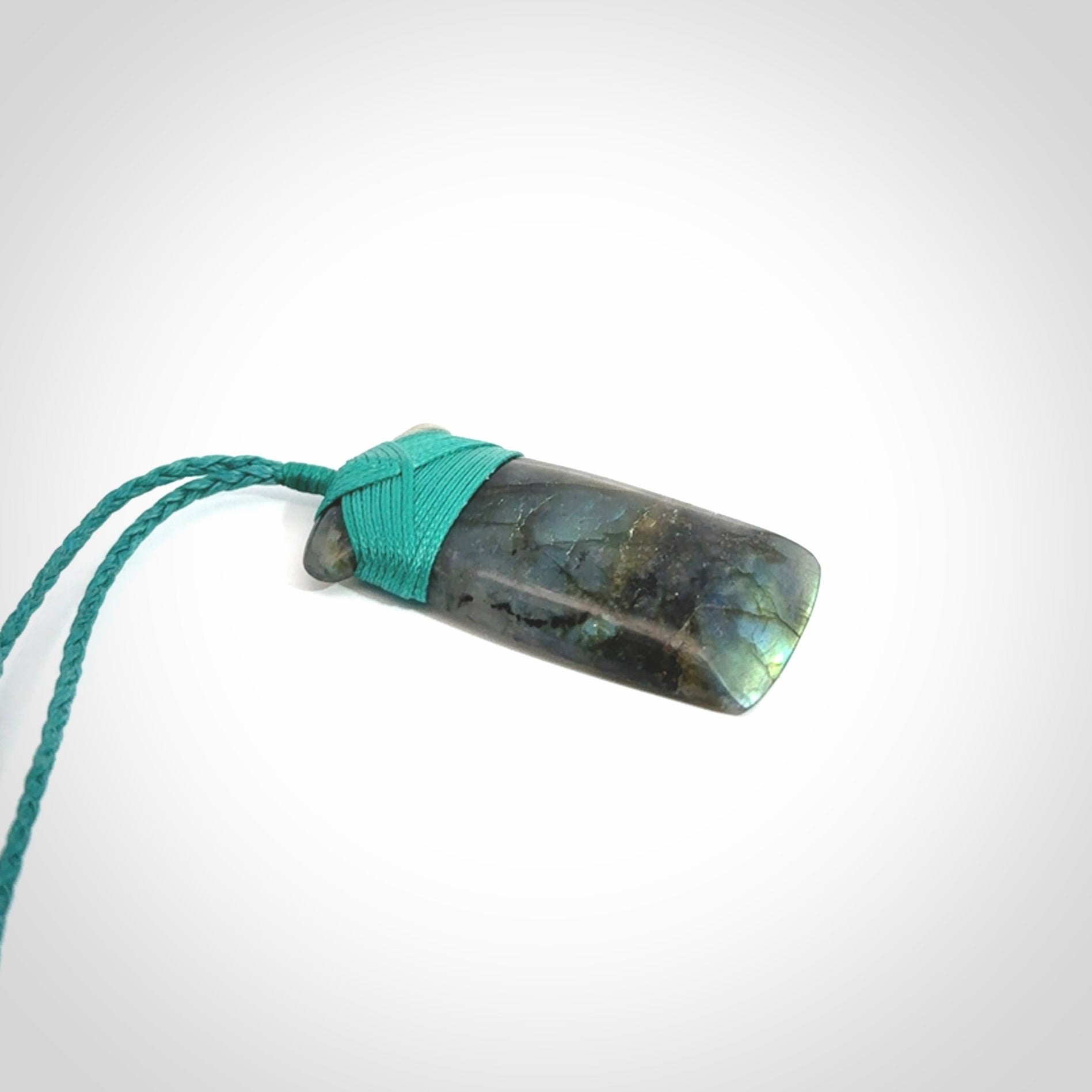 This picture shows a Labradorite stone toki pendant that we have hand carved.