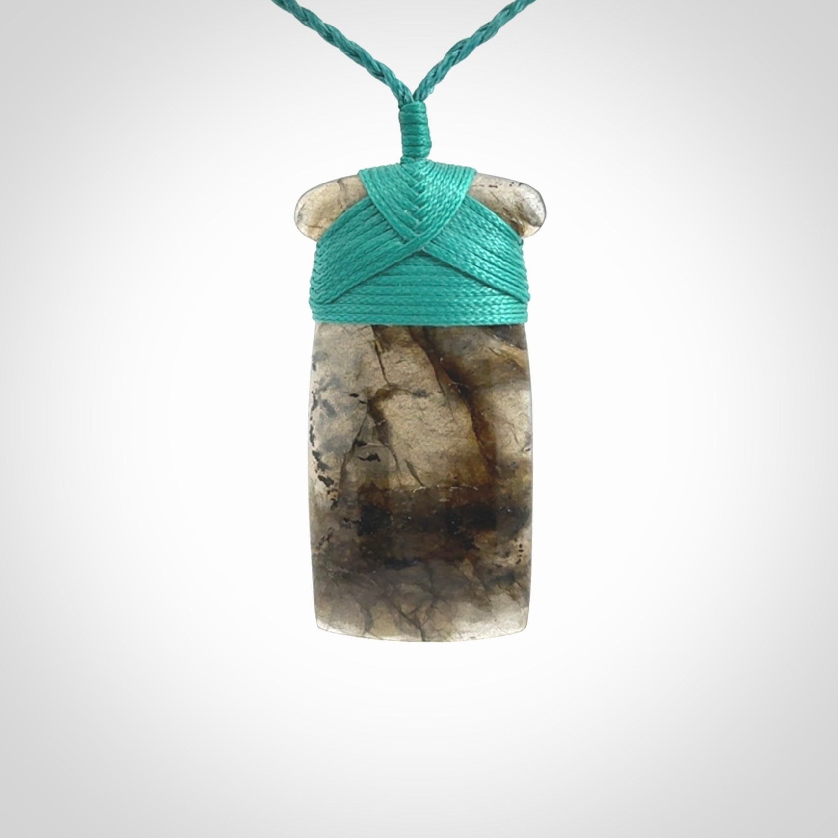 This picture shows a Labradorite stone toki pendant that we have hand carved.