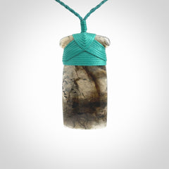 This picture shows a Labradorite stone toki pendant that we have hand carved.
