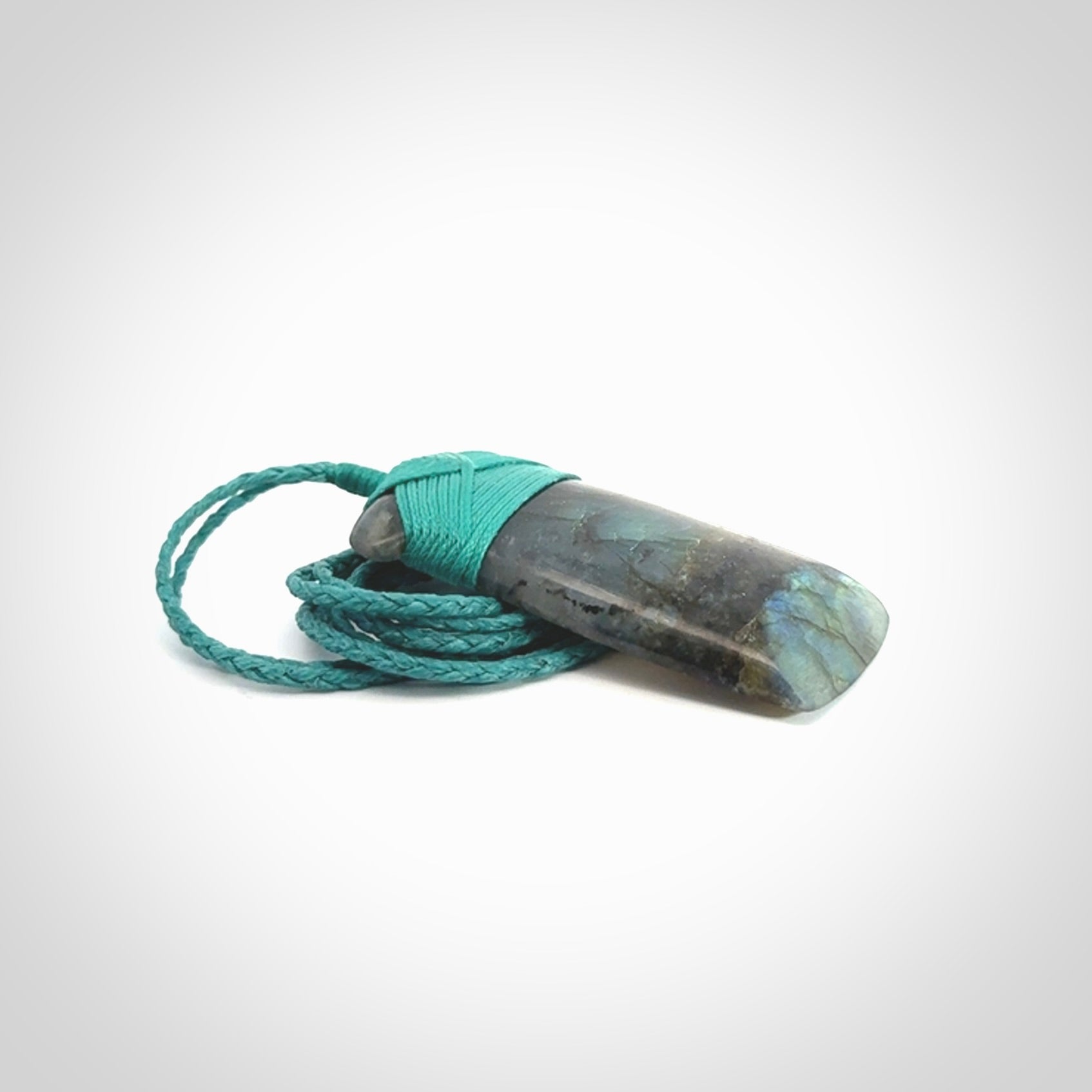 This picture shows a Labradorite stone toki pendant that we have hand carved.