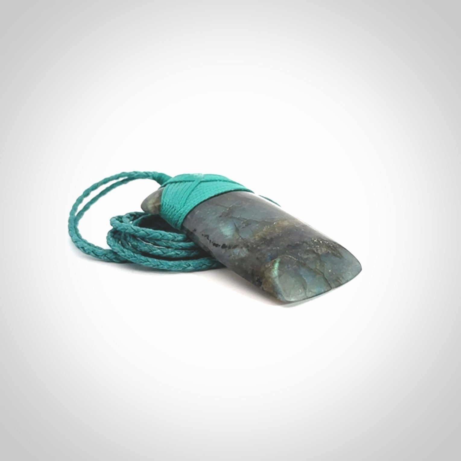 This picture shows a Labradorite stone toki pendant that we have hand carved.